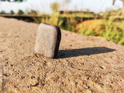 selective focus on stone and long shadow