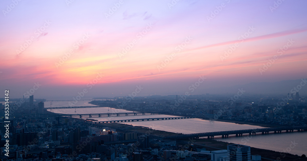 Naklejka premium Beautiful Sunset sky over Osaka city and river aerial view, cityscape