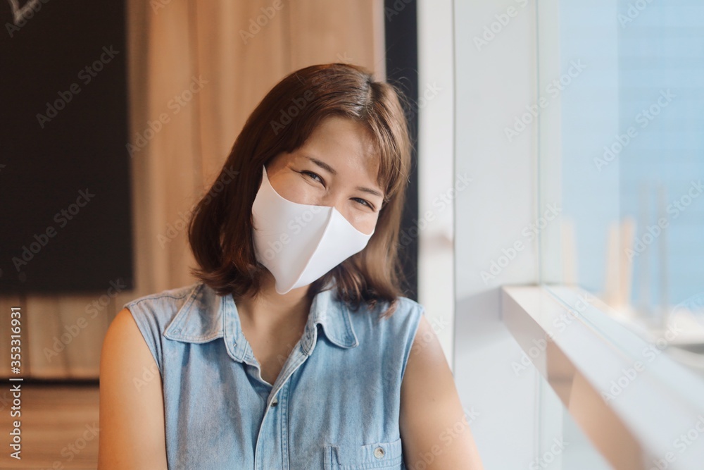 Portrait Happy Asia woman in blue shirt wearing medical mask Portrait Happy Asia woman in blue shirt wearing medical mask