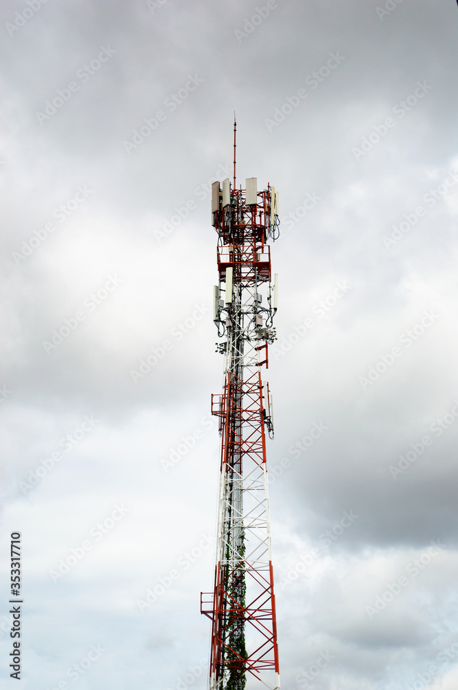 telecommunication pole with white cloud