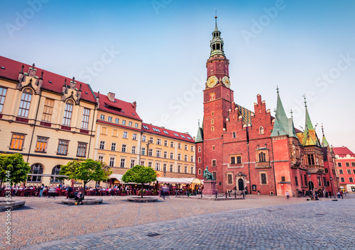 Amazing evening cityscape of Wroclaw, Market Square with Town Hall. Stunning summer scene of historical capital of Silesia, Poland, Europe. Traveling concept background.