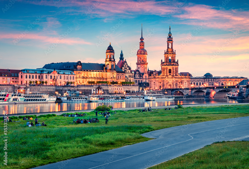 Weekend party on the shore of  Elbe river with Academy of Fine Arts and Baroque church Frauenkirche cathedral on background. Wonderful spring sunset on Dresden, Saxony, Germany, Europe.