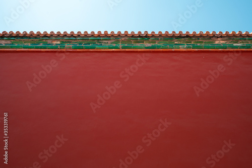 Chinese traditional red wall with blue sky. Minimal background.