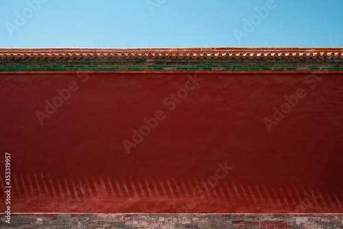 Chinese traditional red wall with blue sky. Minimal background.