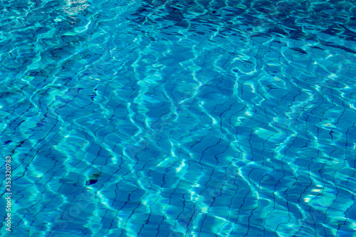 water reflection on blue tile in swimming pool