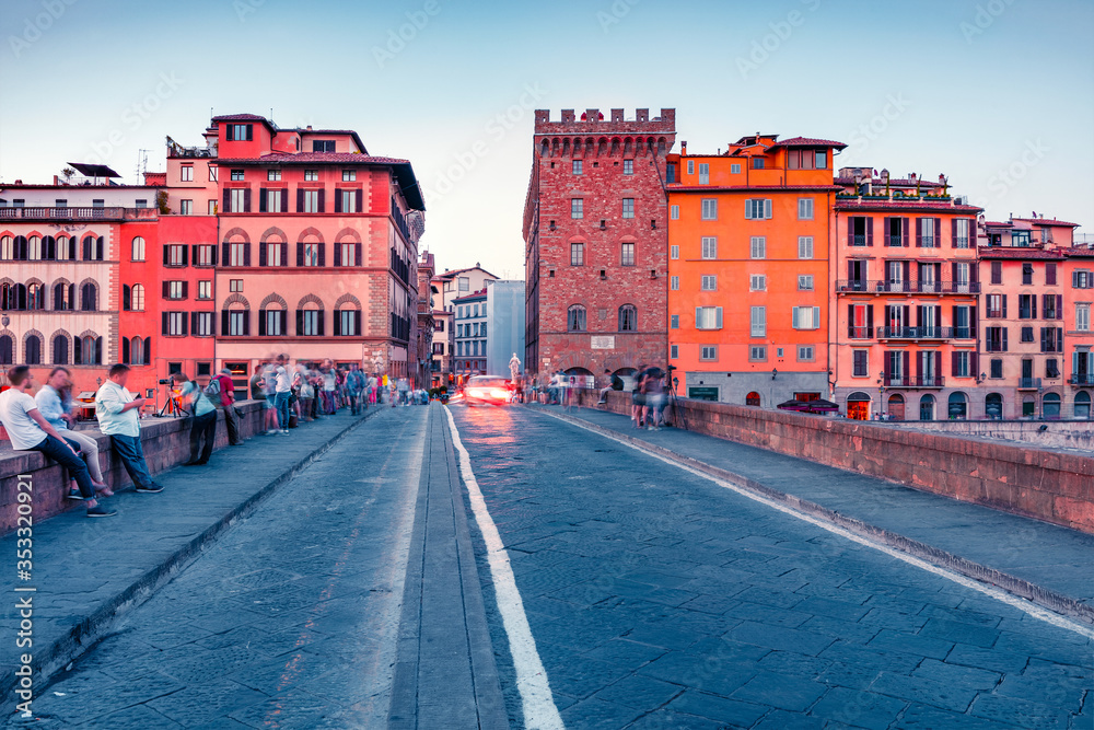 A lots of tourist spending evening on the St Trinity Bridge in Florence. Colorful summser scene of Tuscany, Italy, Europe. Traveling concept background..