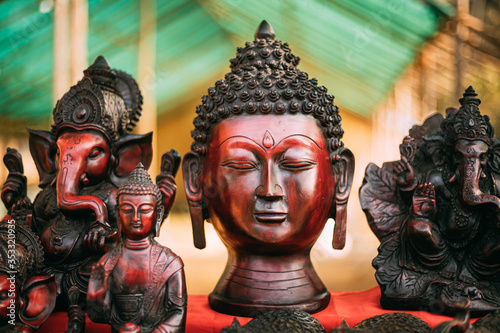 Goa, India. Traditional Store With Statues Different Colors And Sizes. Statues Of Buddha Head And Ganesha On Market