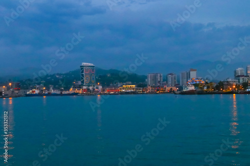 Batumi, Adjara, Georgia. View from the sea on illuminated resort town at evening © olyasolodenko