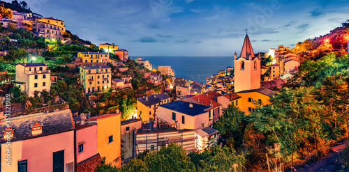 Astonishing evening cityscape of Riomaggiore, first city of the Cique Terre sequence of hill cities . Fantastic sunset in Liguria, Italy, Europe. Great evening seascape of Mediterranean country.