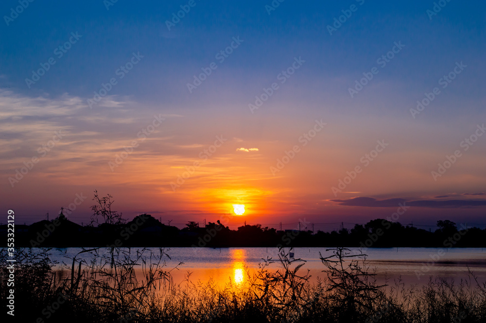 Fototapeta premium landscape silhouette sunset in to river with blue sky