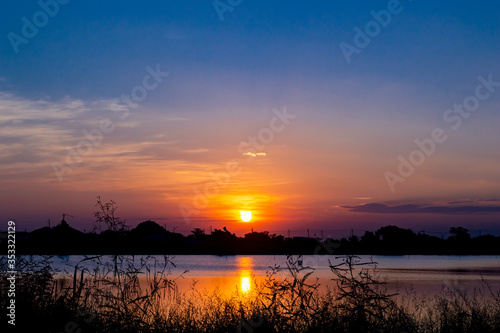 landscape silhouette sunset in to river with blue sky