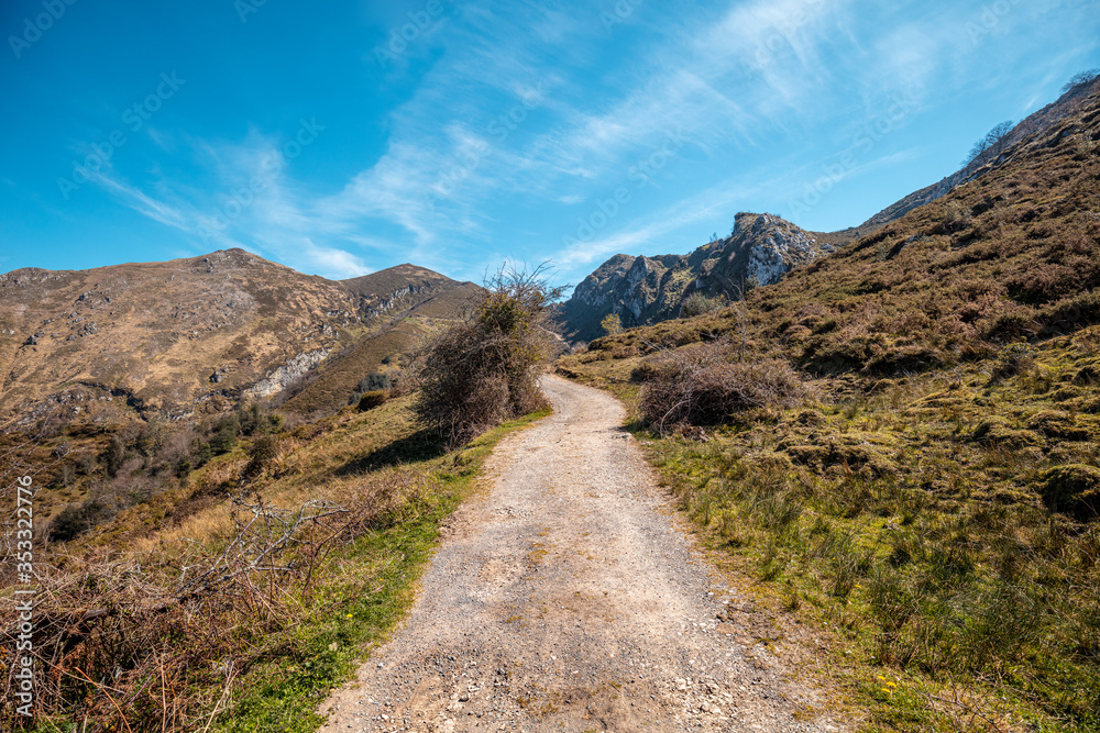 View of beautiful mountain landscape on a sunny day. Mountain dirt road in National park Picos de Europa. Cantabria, Spain, Europe