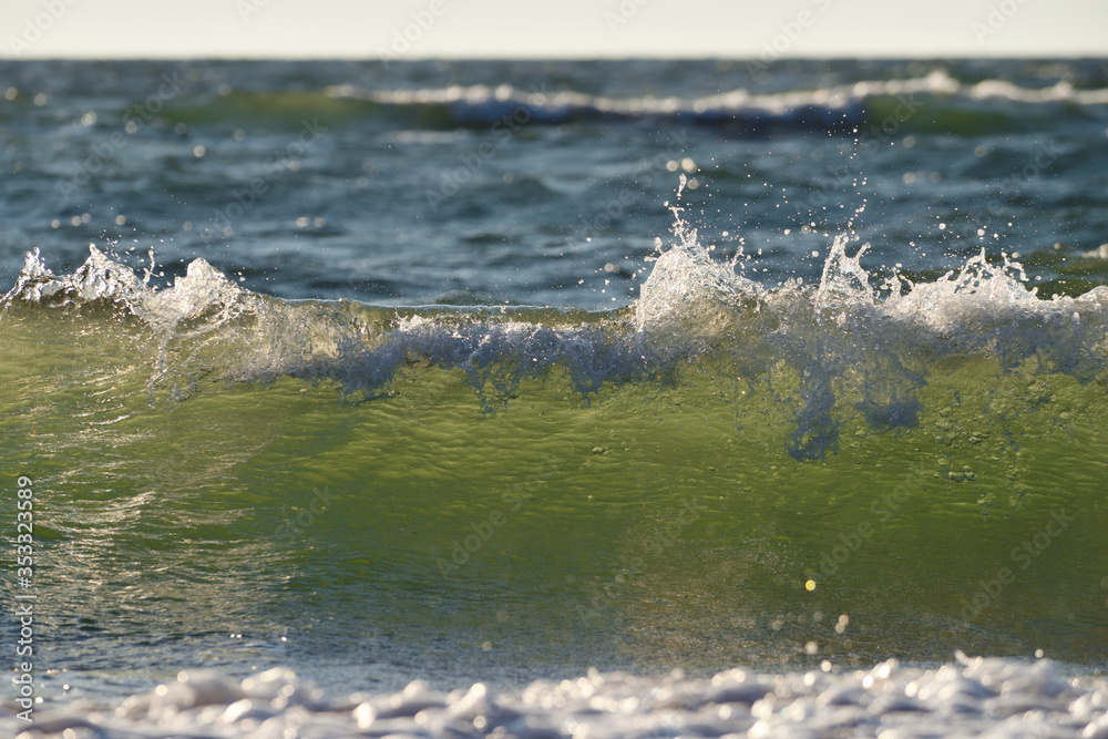 Obraz premium Sea or ocean, waves close-up view. Green - yellow waves sea water