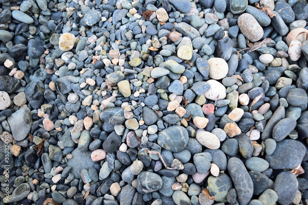 Pebbles on the Kipos beach in Samothraki island, Greece, Aegean sea. Sea rocks. Background, Texture, Detail, close up Pebbles on the Kipos beach in Samothraki island, Greece, Aegean sea. Sea rocks. Background, Texture, Detail, close up