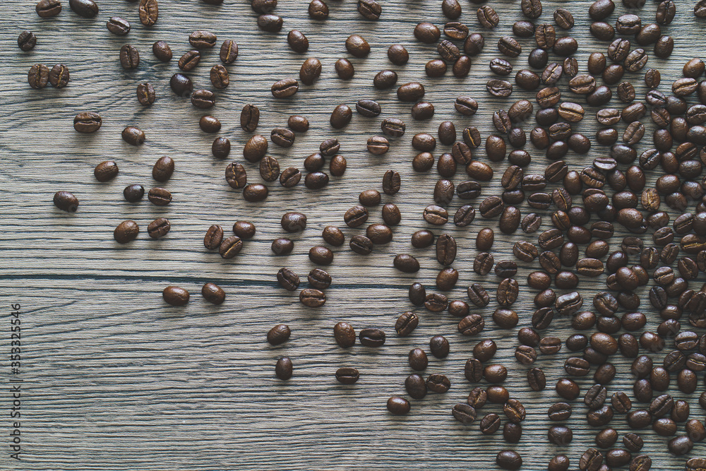 Fototapeta premium Coffee beans. On a wooden background. Top view