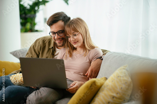 Young couple watching movie on lap top. Loving couple enjoying at home.  © JustLife