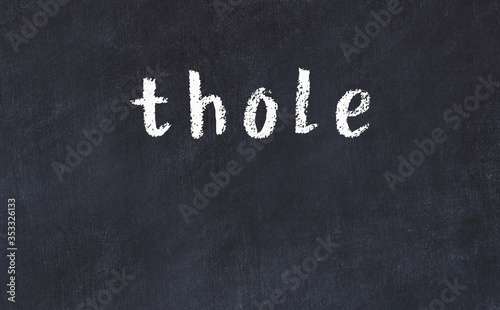 College chalk desk with the word thole written on in photo