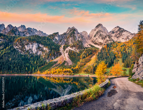 Magnificent autumn view of Gosausee (Vorderer) lake with asphalt walkway road. Spectacular morning scene of Austrian Alps, Upper Austria, Europe. Beauty of nature concept background. © Andrew Mayovskyy