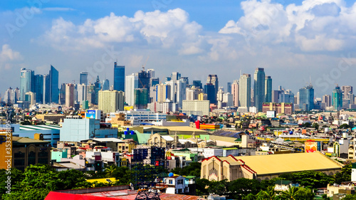 Paranaque, Metro Manila, Philippines - Jan 2016: Baclaran Church with Makati Skyline in background. photo