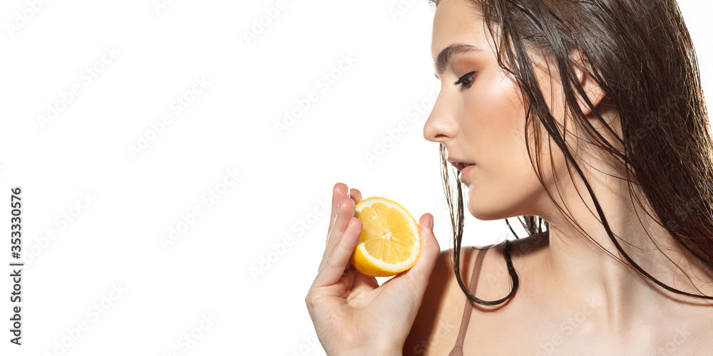 Close up of beautiful young woman with lemon slices on white background. Concept of cosmetics, makeup, natural and eco treatment, skin care. Shiny and healthy skin, healthcare. Flyer with copyspace. Close up of beautiful young woman with lemon slices on white background. Concept of cosmetics, makeup, natural and eco treatment, skin care. Shiny and healthy skin, healthcare. Flyer with copyspace.