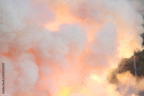 Sudden loud massive explosion of bomb. Blast wave. Huge volumes of black smoke and sparks of fire. Detonation of bomb or cannon ball. Outburst close up. Smoke texture concept in gentle pastel colors