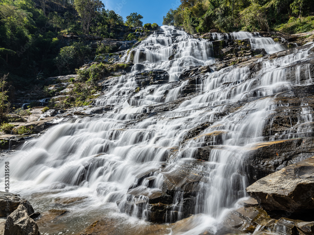 Fototapeta premium Beautiful Smooth Waterfall with blue sky