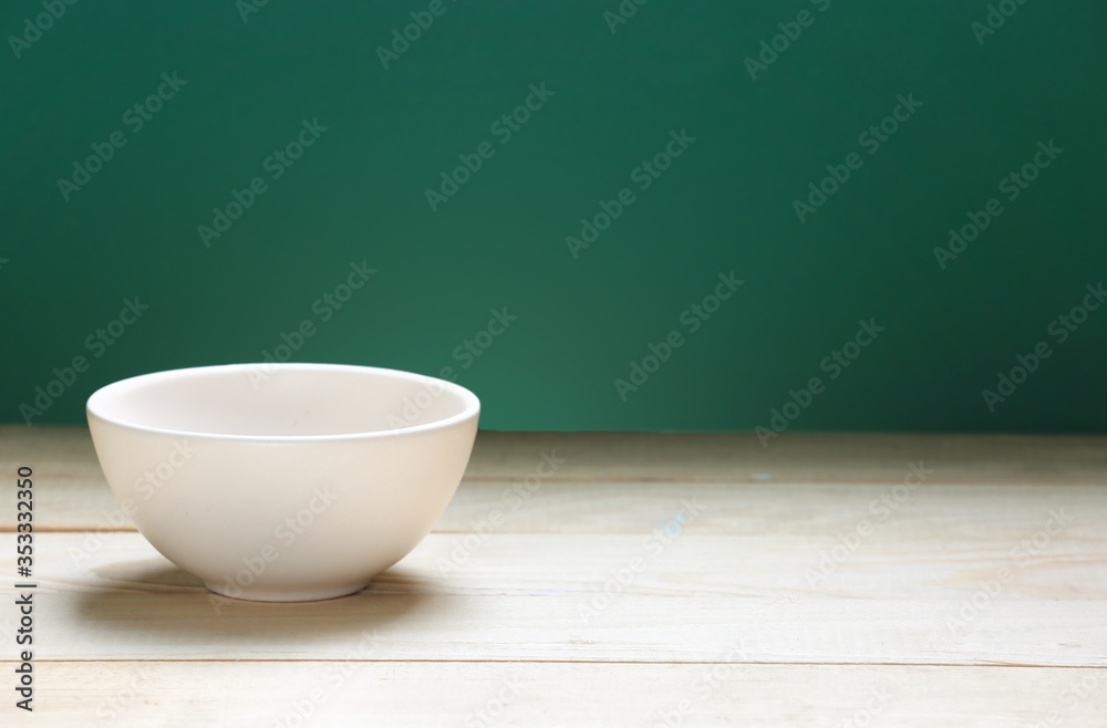 Bowl on wooden empty space table and green background.Food backdrop. Bowl on wooden empty space table and green background.Food backdrop.