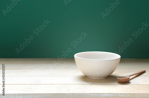 Bowl on wooden empty space table and green background.Food backdrop.