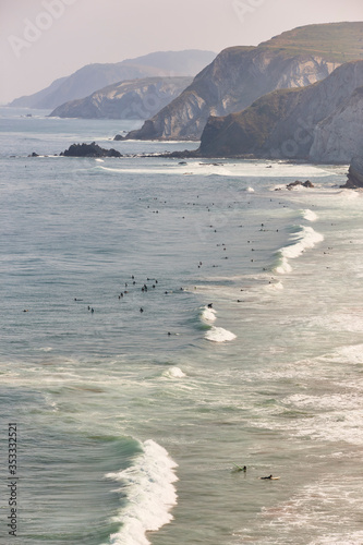 Surfing in spanish coastline. La Salvaje beach. Basque country, Spain photo