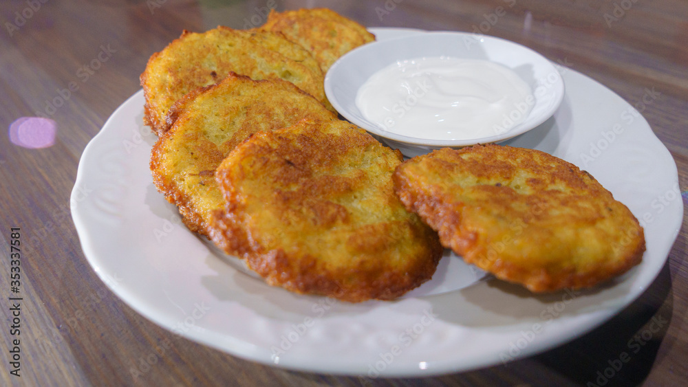 Potato pancakes, draniki, hash browns or fritters served with fresh cream.