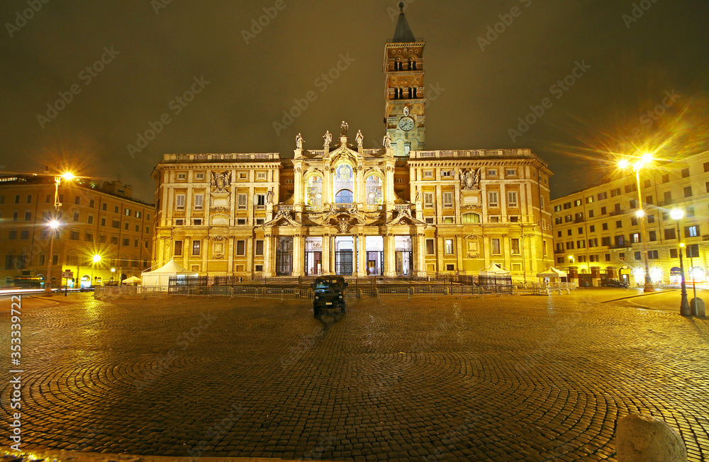 Fototapeta premium Rome, Italy - March, 07, 2018: Façade of Papal Basilica di Santa Maria Maggiore with anciaent mosaics facing the Piazza at night. Charming place in Eternal city. Vacation abroad in heart of old Europe
