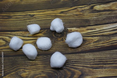 Cutton balls isolated on wood background photo