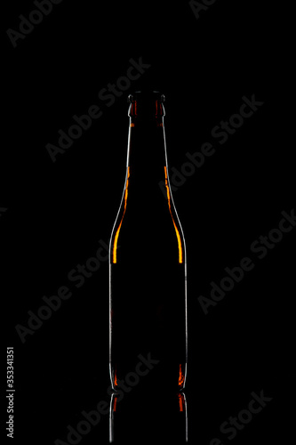 Silhouette of a beer bottle on black background