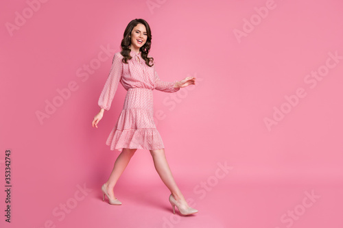 Full size profile side photo of candid content girl go walk copyspace enjoy free time isolated over pink color background