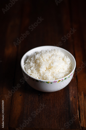 Cooked Thai jasmine rice on wooden background - vintage filter