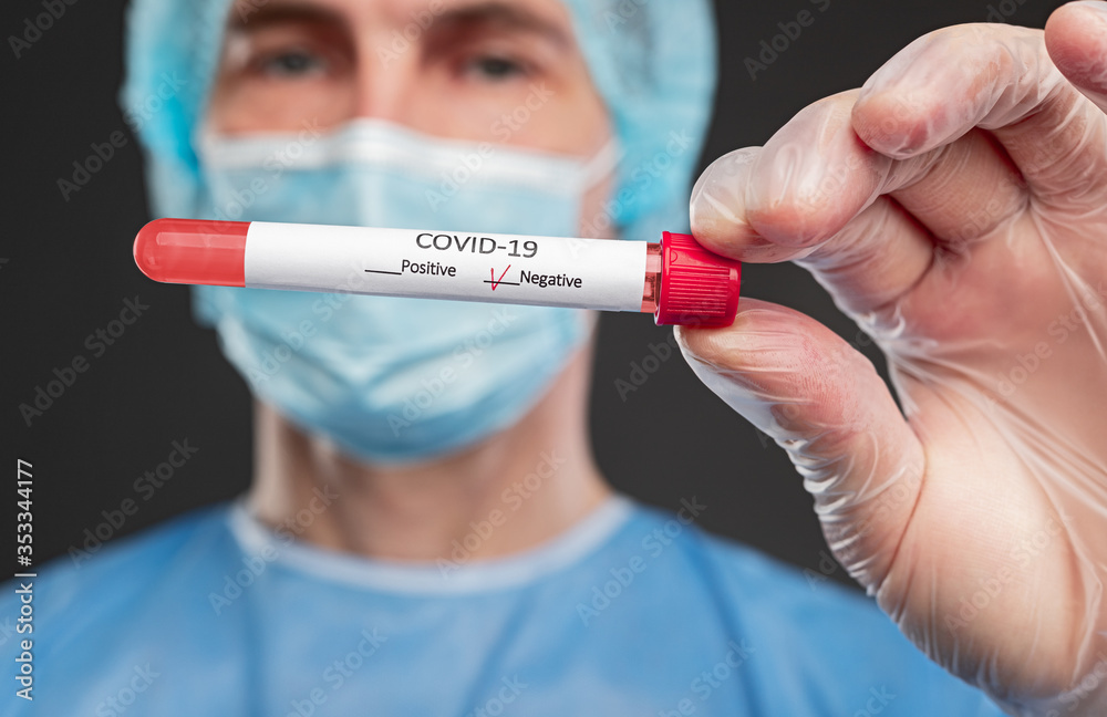 Doctor with coronavirus test tube with negative result