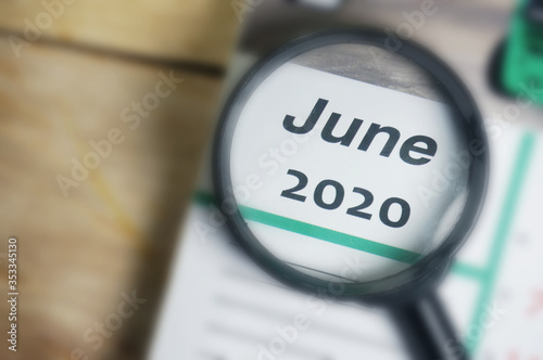 Wallpaper Mural June 2020 Calender under magnifying glass. Selective focus. Torontodigital.ca