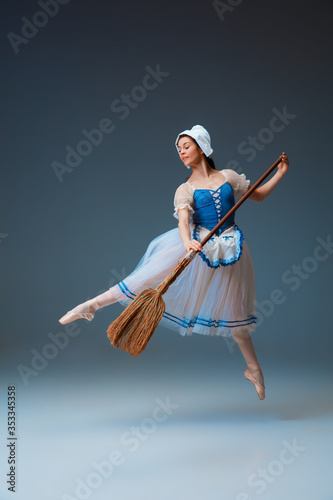 In flight. Young and graceful female ballet dancer as Cindrella fairytail character on studio background. Art, motion, action, flexibility, inspiration concept. Flexible ballerina in inspired dancing. photo