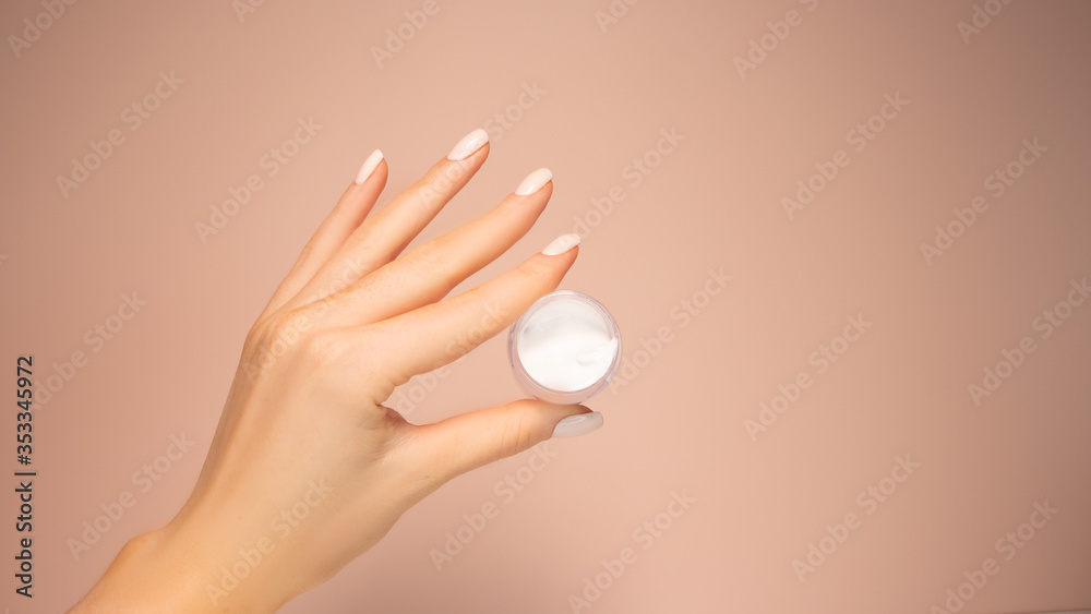 Beautiful hands hold a jar of cream. Beautiful hands hold a jar of cream.