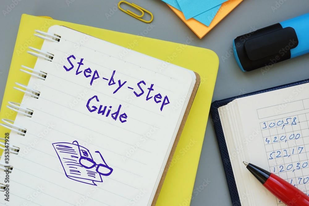 Financial concept about Step-by-Step Guide with phrase on the piece of paper. Financial concept about Step-by-Step Guide with phrase on the piece of paper.