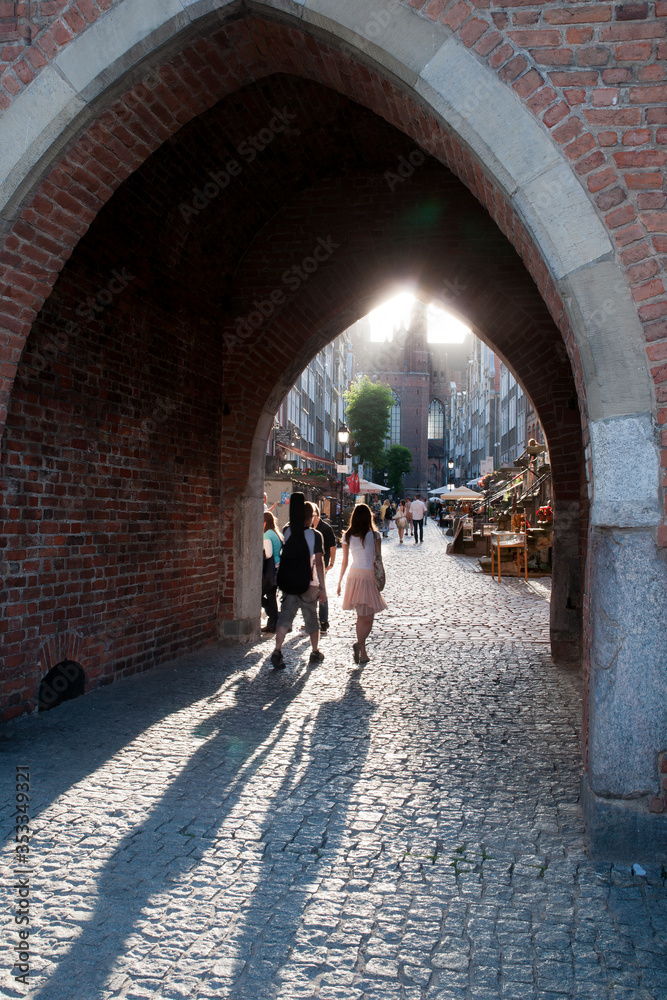Gdansk Poland, Old town view through archway with long afternoon shadows