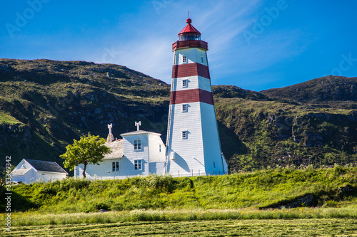 Alnes lighthouse at clear sumer sky at Godoy island near Alesund, Norway