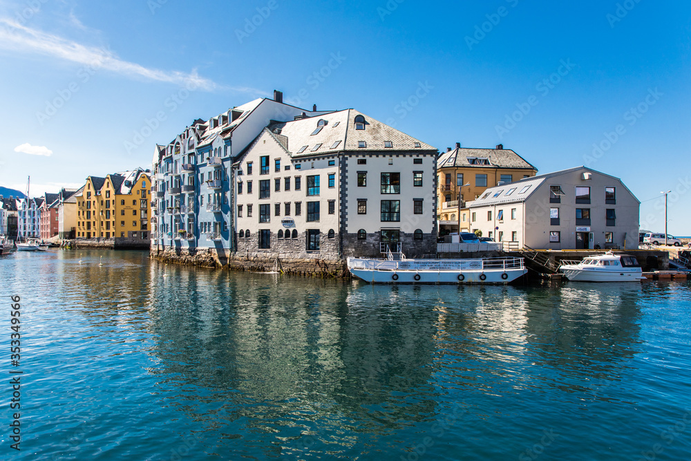 Alesund, Norway - June 2019: View of colorful Art Nouveau architecture in the port of the city of Alesund, Norway. Panoramic view of Alesunds architecture and docked sailing boats and vessels.