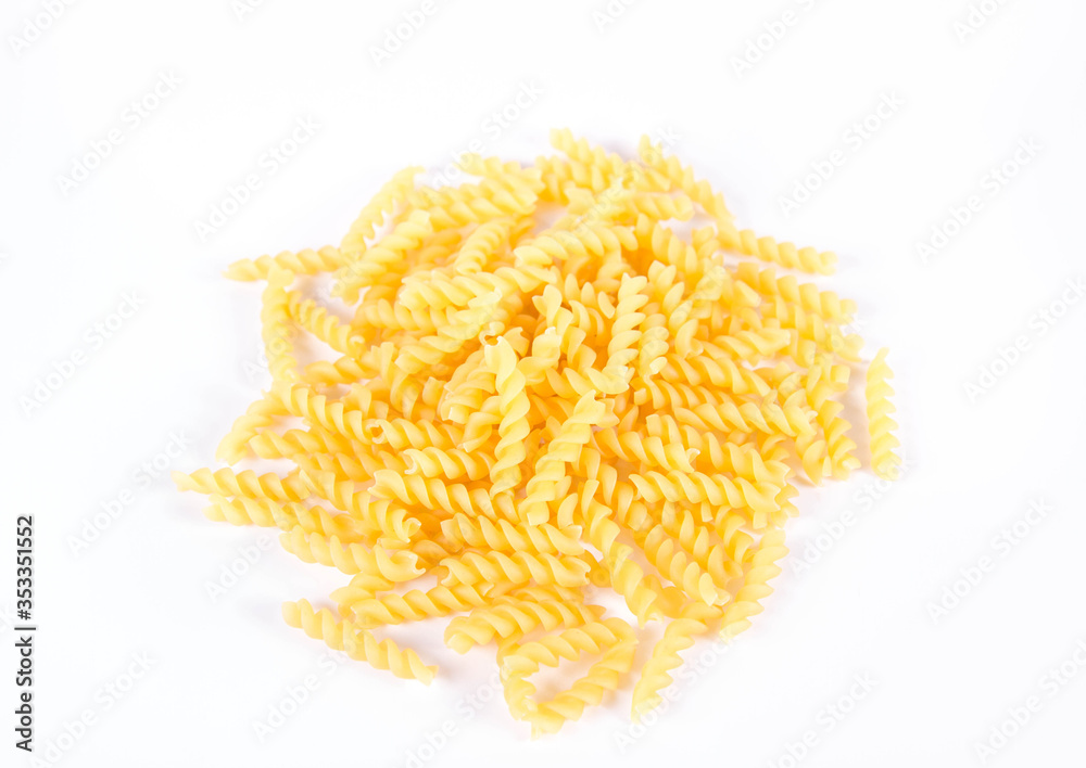 Fototapeta premium Raw fusilli pasta on a white background