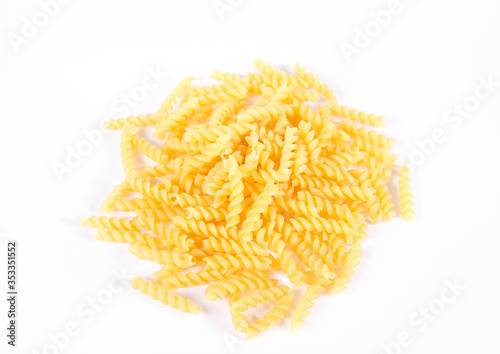 Raw fusilli pasta on a white background