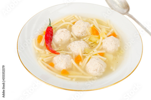 Broth with noodles and meat balls. Photo