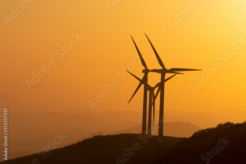 eolic wind generators at sunset photo