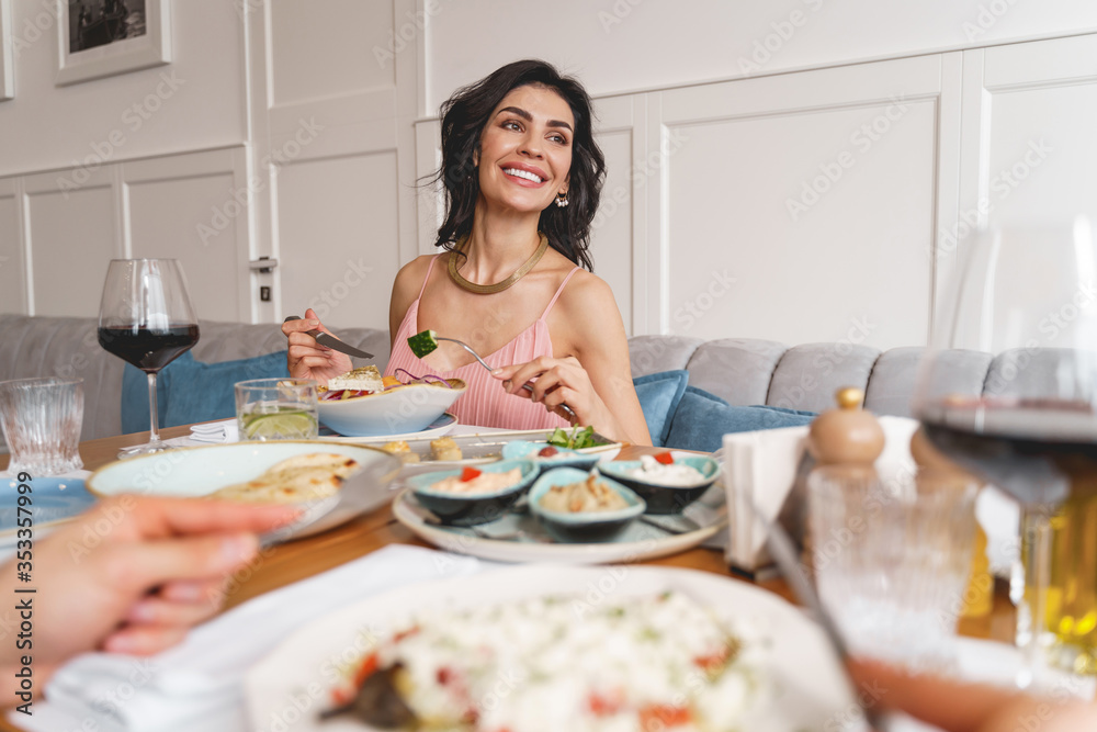 Attractive young woman having dinner in restaurant