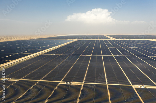 Photography Aerial view of a landscape with photovoltaic solar panel farm producing sustainable renewable energy in a desert power plant