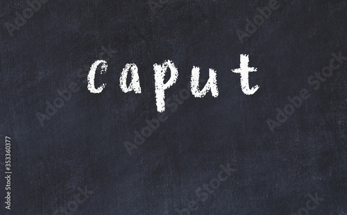 College chalk desk with the word caput written on in